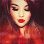 Leanna Kerry with red hair looking down