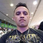 Mike Pomana wear black tee shirt and necklace